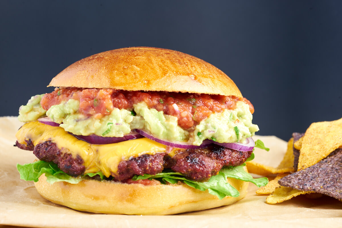 juicy mexican burger with guacamole, cheddar and salsa