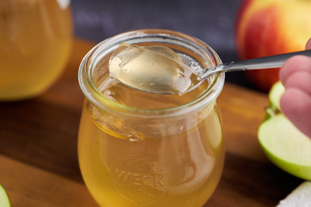 jar with apple jelly with spoon in