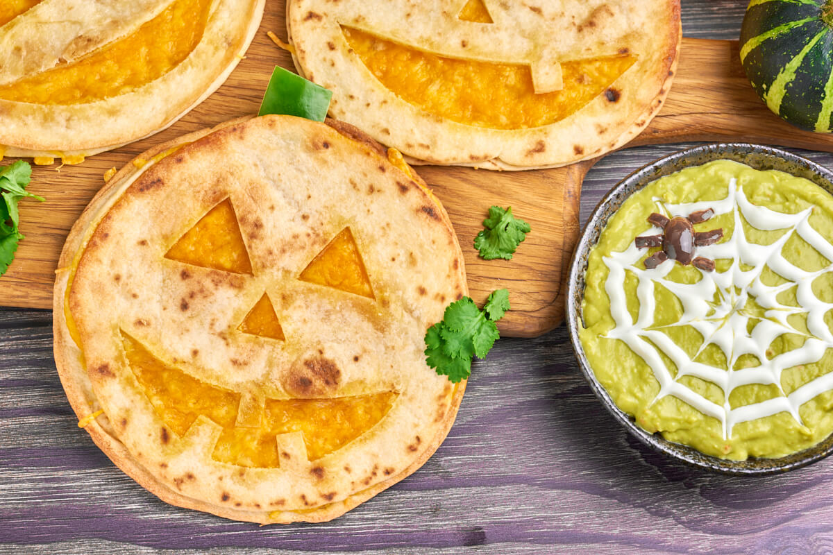 Jack o Lantern quesadillas as pumpkin lantern man with creepy guacamole