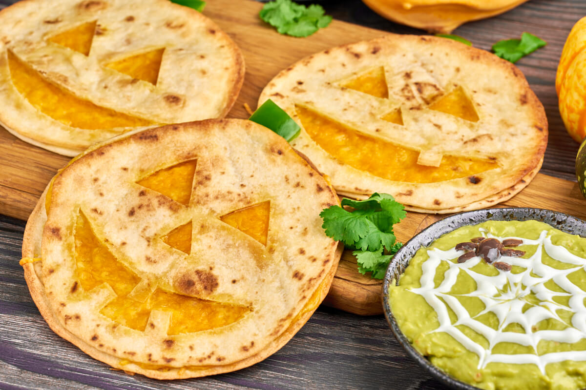 jack o lantern quesadillas for halloween served with spider guacamole