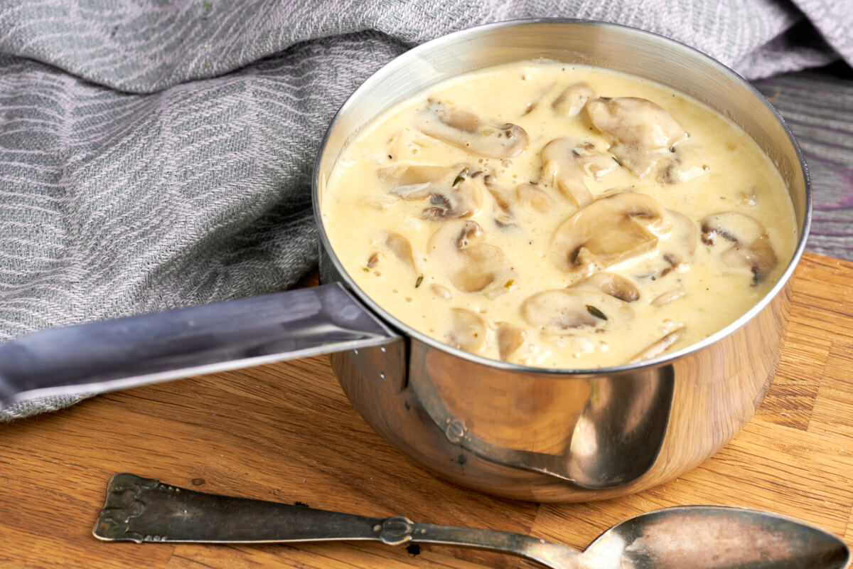 pot of white sauce with mushrooms