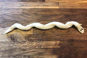 snake bread around wooden skewer