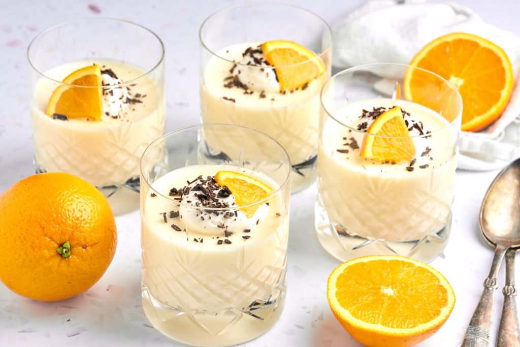 orange mousse in dessert glass with dark chocolate on top
