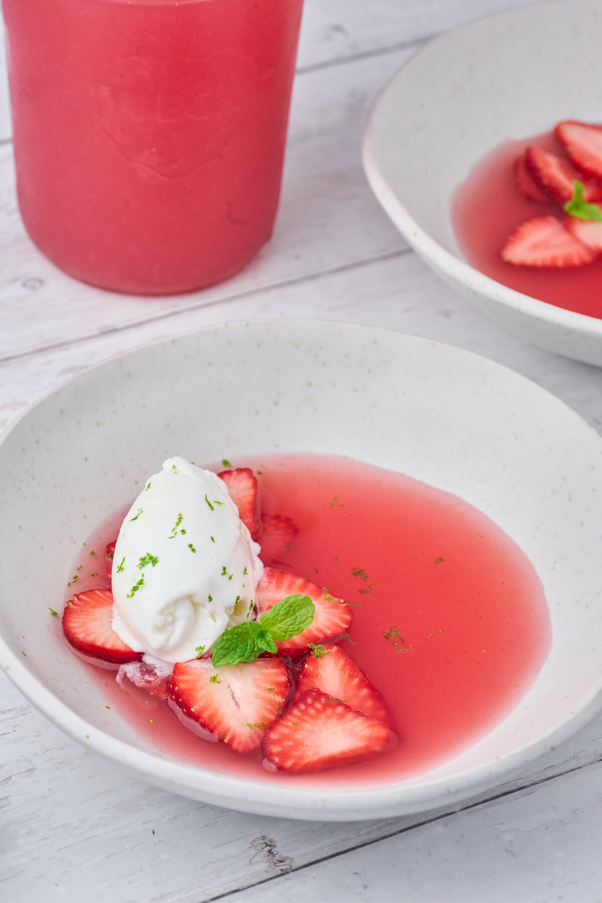 plate with danish cold rhubarb soup with strawberries and icecream.