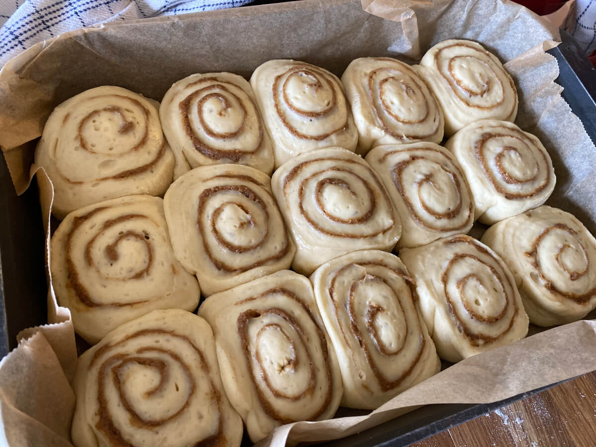 danish cinnamon snails in baking tray with high edges