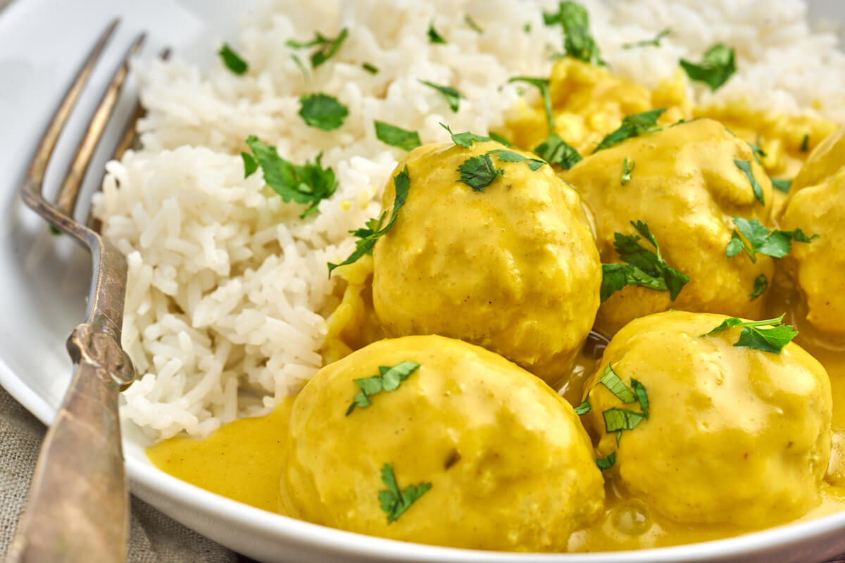 bowl with danish meatballs in curry sauce