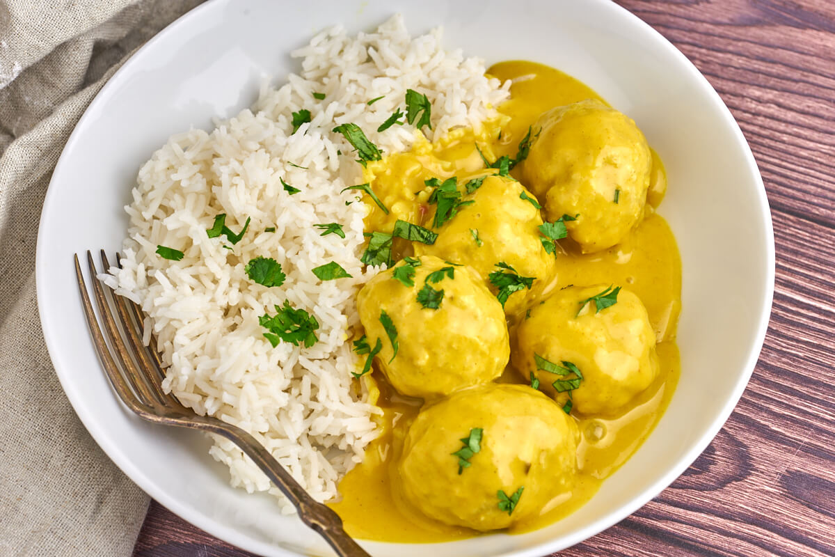 plate with danish meatballs in curry sauce