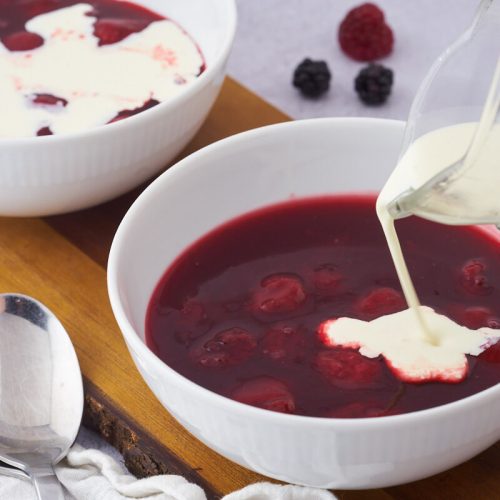 danish red berry pudding with strawberries and cream