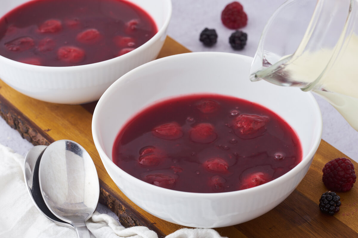 two bowls of red berry pudding and cream