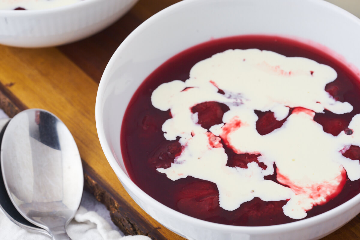 danish red berry pudding with cream on top