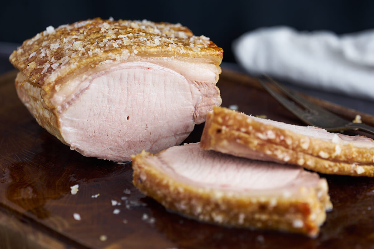 danish roast pork with crackling on wooden board