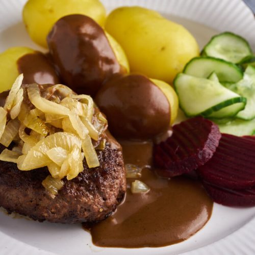 danish beef patties with soft onions, potatoes, grawy and danish cucumber salad