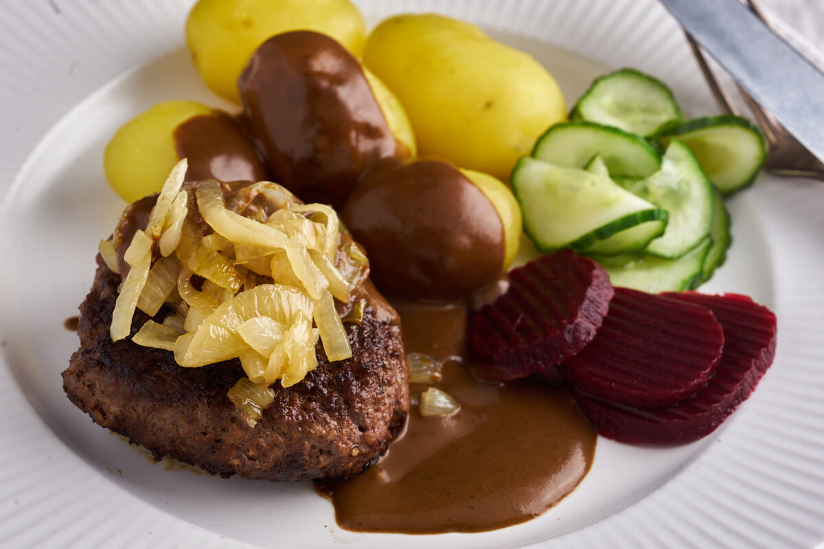 danish beef patties with soft onions, potatoes, grawy and danish cucumber salad