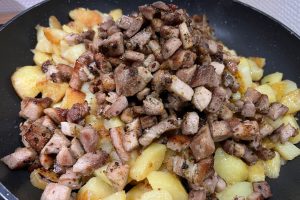 potatoes and roast pork on the pan