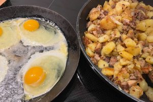 danish hash (biksemad) and fried eggs on frying pans