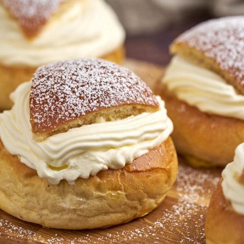 semlor swedish lenten buns with cream and icing sugar on top