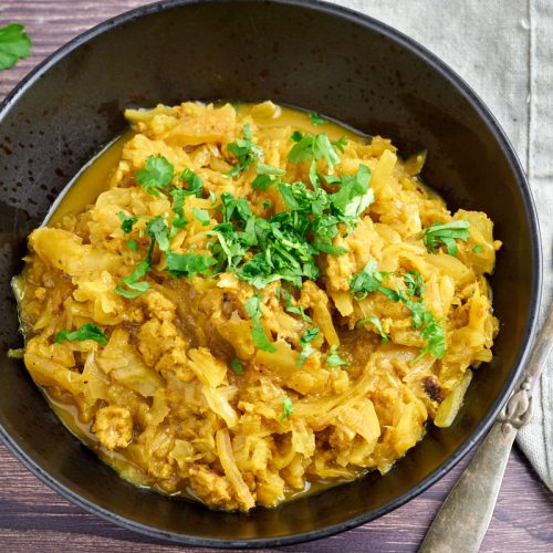 curried cabbage and chicken with coriander on top