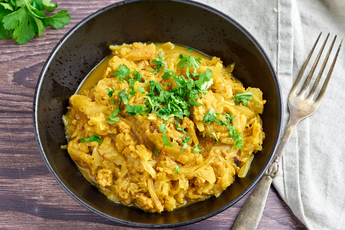 curried cabbage and chicken with coriander on top