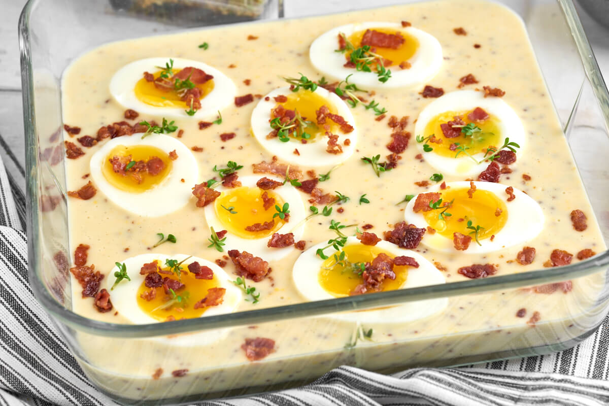 dish with smiling eggs in mustard sauce