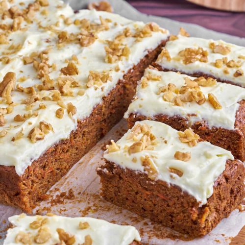 carrot cake with cream cheese frosting and walnuts on top