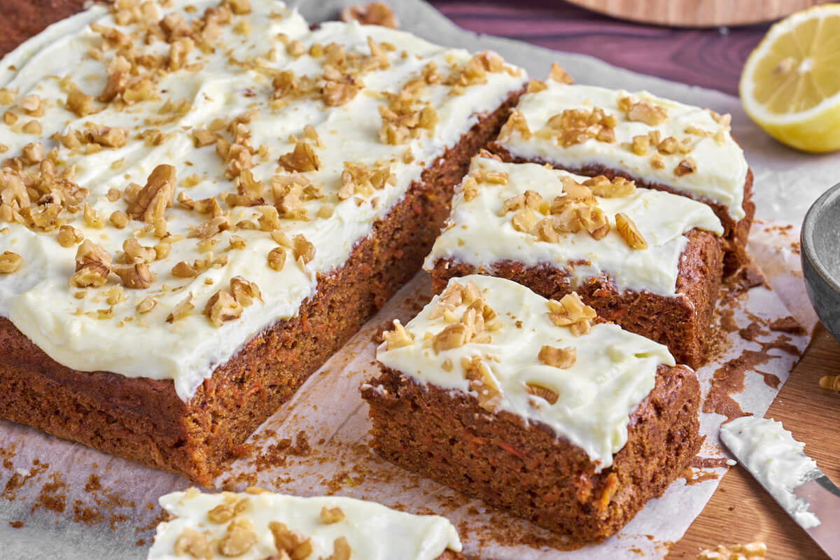 carrot cake with cream cheese frosting and walnuts on top