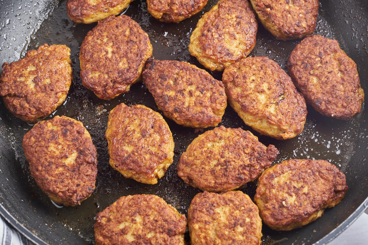 danish ground chicken meatballs on frying pan