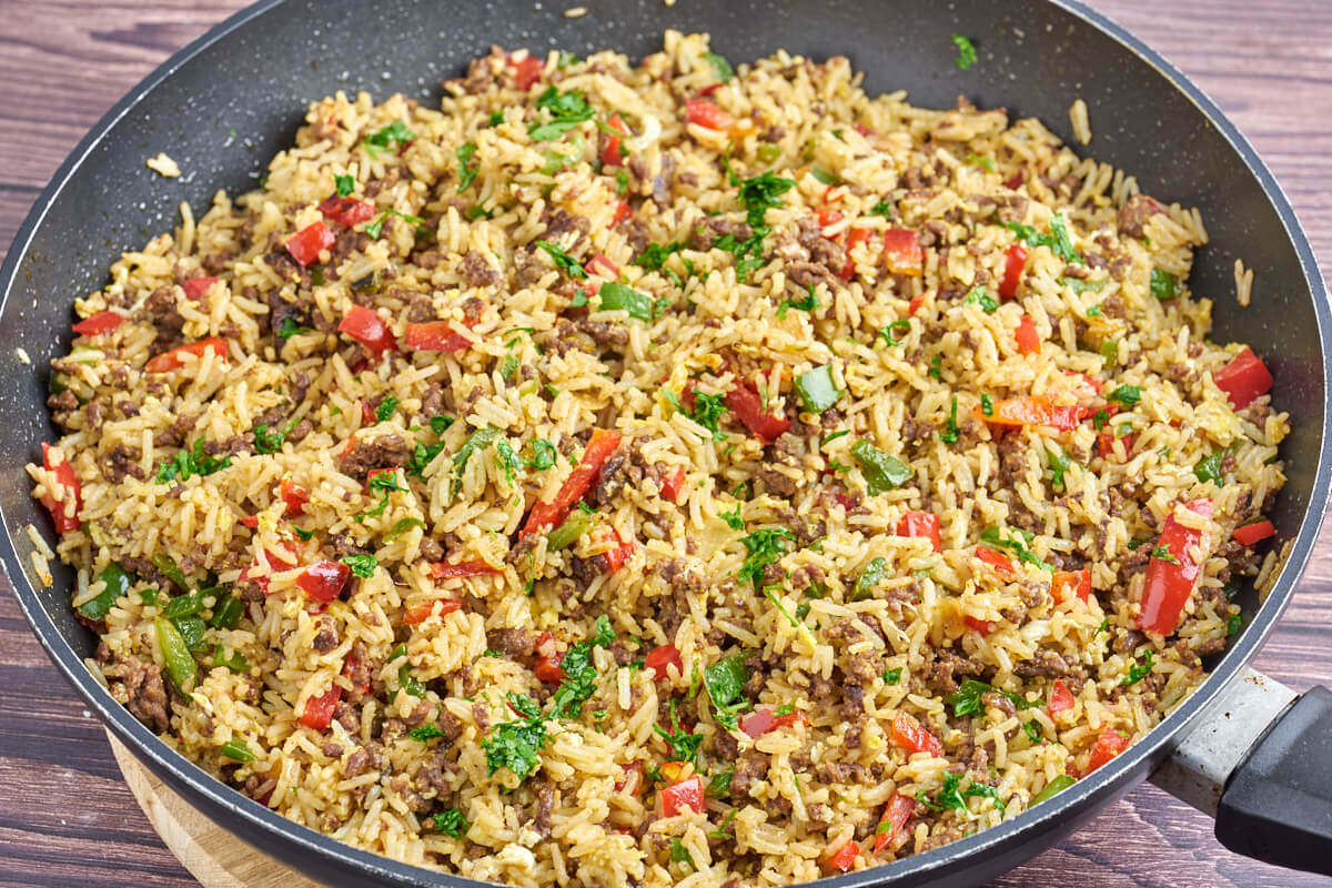 frying pan with fried rice with gound beef and bell peppers