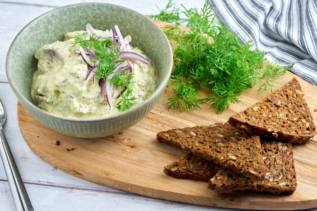 danish pickled herring in mustard sauce with rye bread