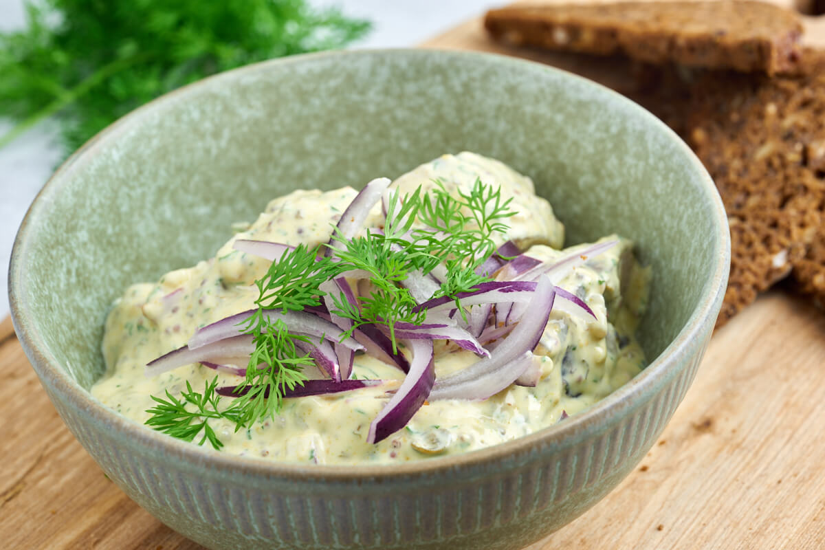 bowl of danish pickled herring in mustard sauce