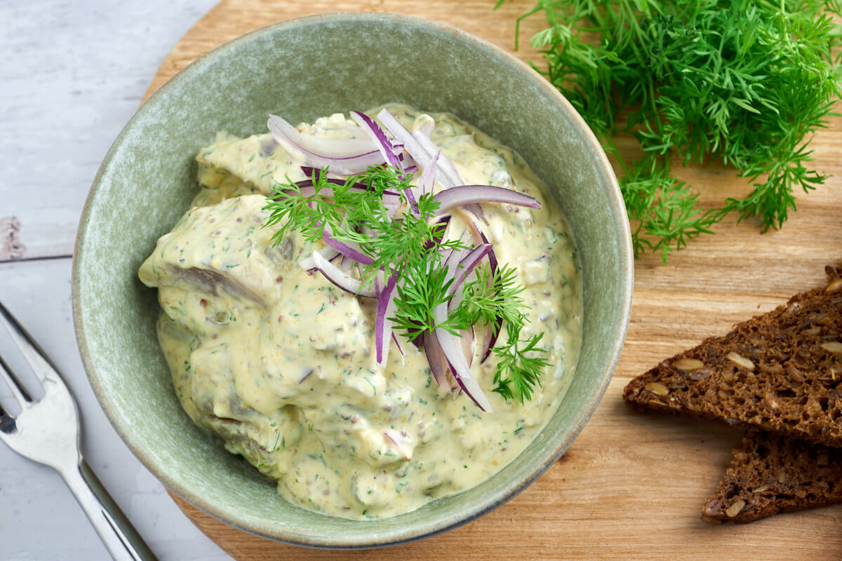 Danish or swedish pickled herring in mustard sauce served with rye bread
