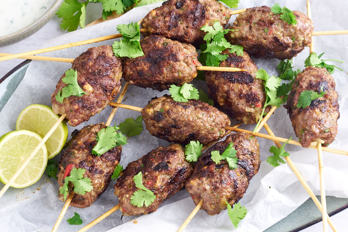 kofta on skewers with cilantro and lime