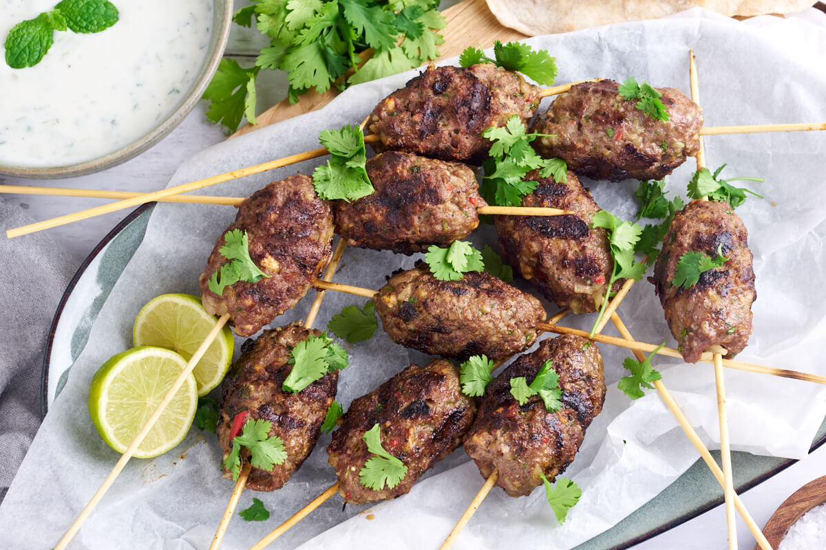 kofta skewers with cilantro and lime served with raita dip