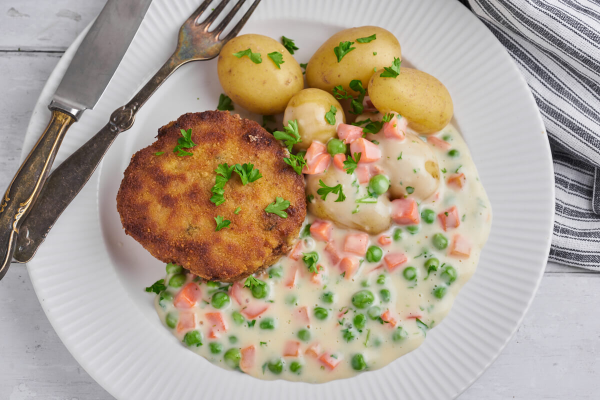 Danish karbonader or krebinetter with pea and carrot stew and potatoes
