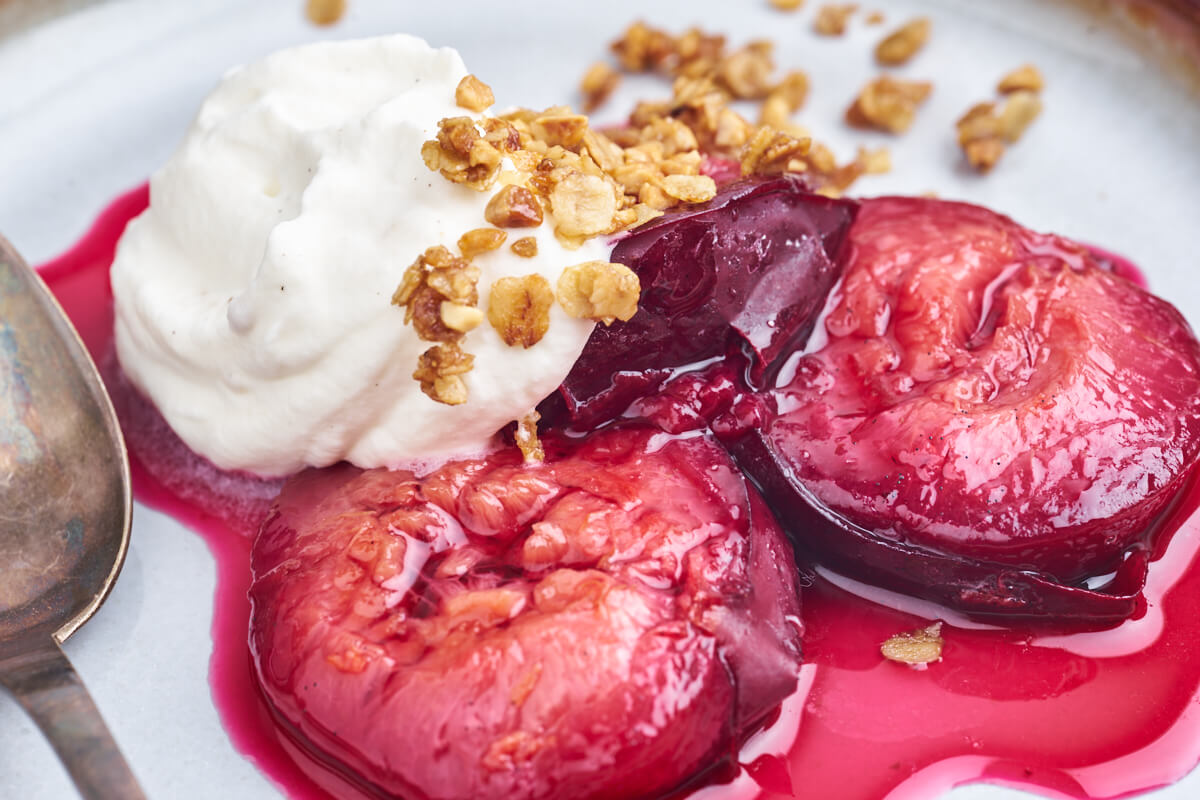 baked plums with whipped cream and crumble