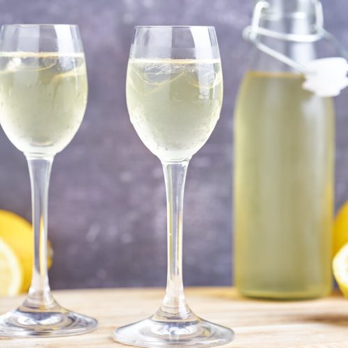 Italian limoncello in glasses and a bottle of lemon liqueur