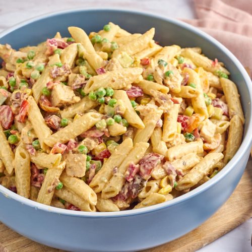 pasta salad with chicken and bacon in blue bowl