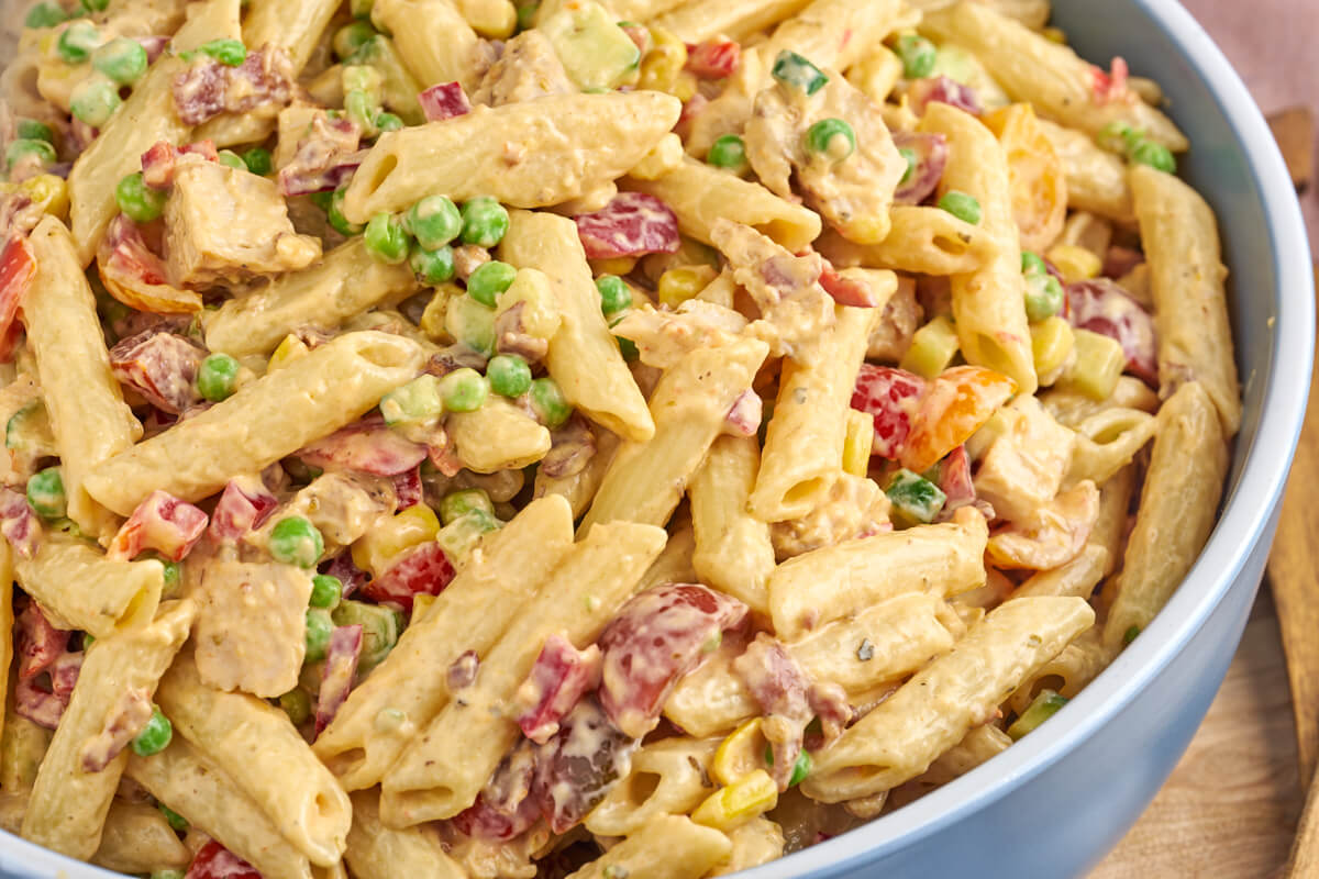 pasta salad with chicken and bacon and different vegetables in bowl