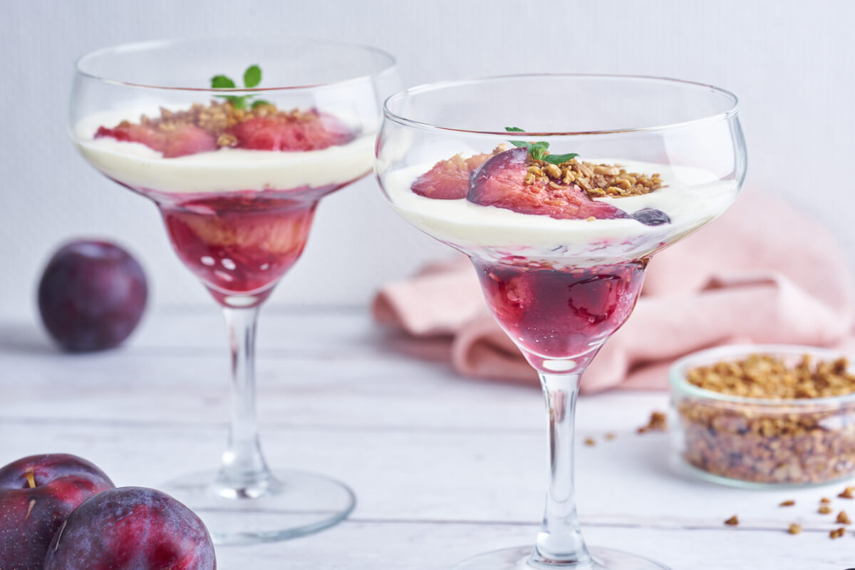 plum trifle in glasses with baked plums