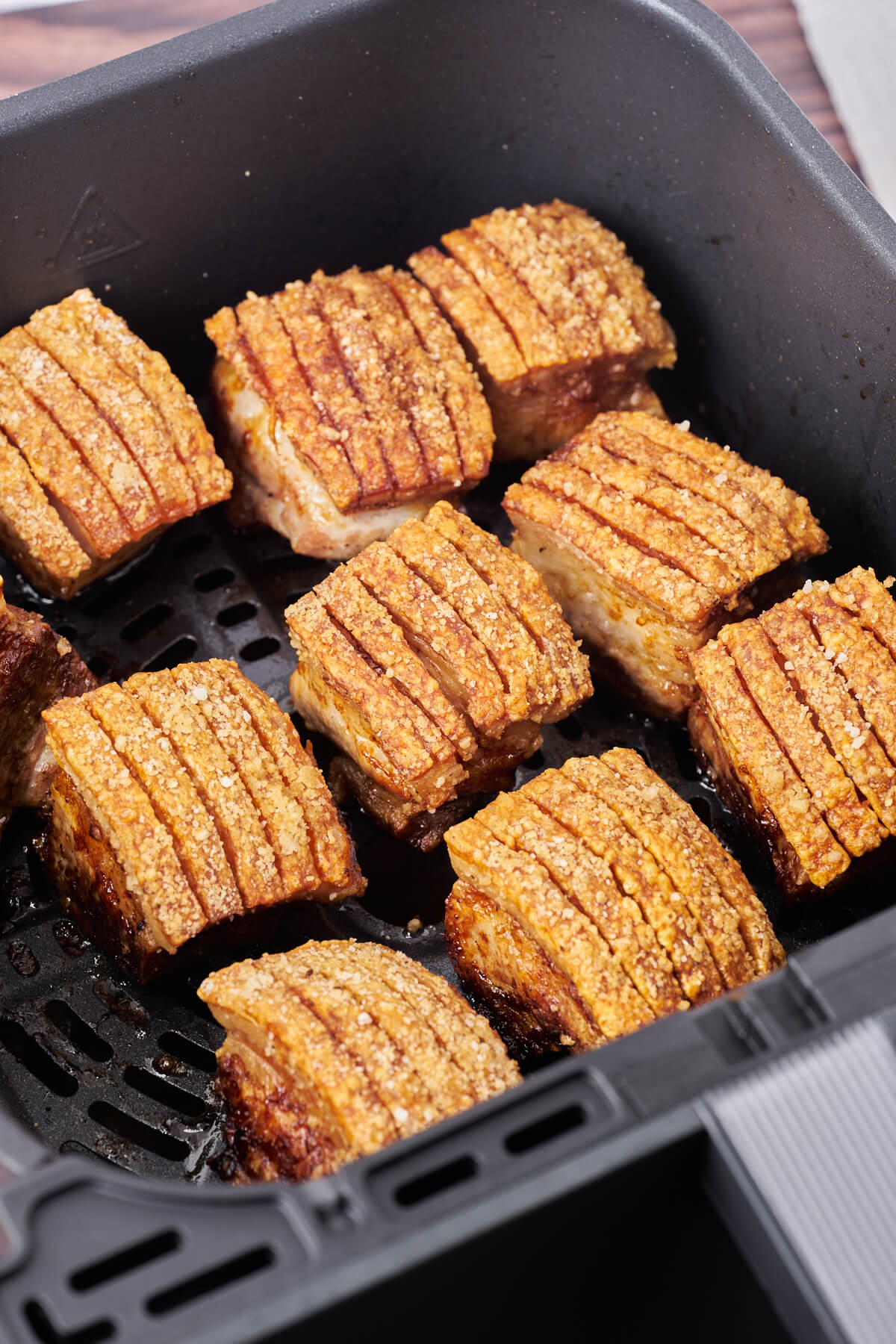 air fryer basket with pork belly roast with crispy crackling