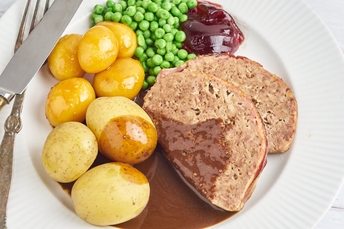 Danish dinner with meatloaf, potatoes, peas and gravy