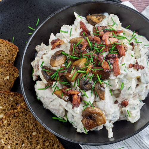 Danish chicken salad with bacon and mushrooms served with rye bread