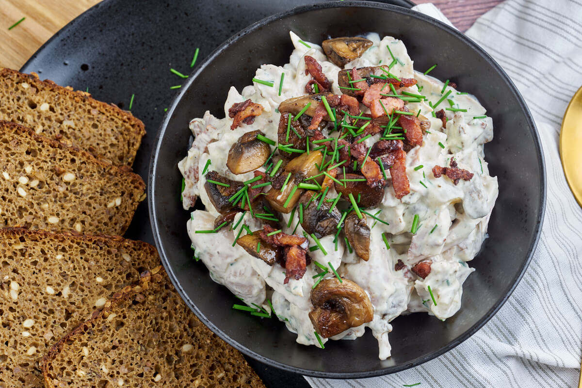 Danish chicken salad with bacon and mushrooms served with rye bread