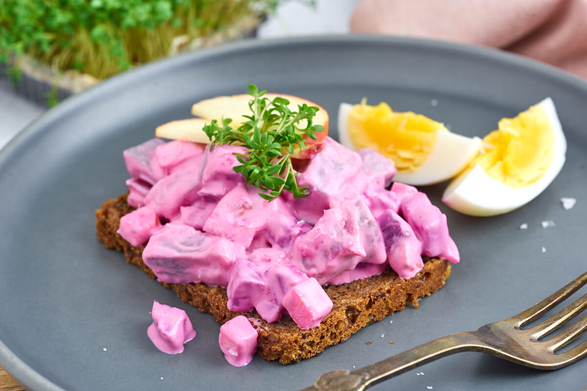 Danish herring salad on rye bread with boiled egg end cress