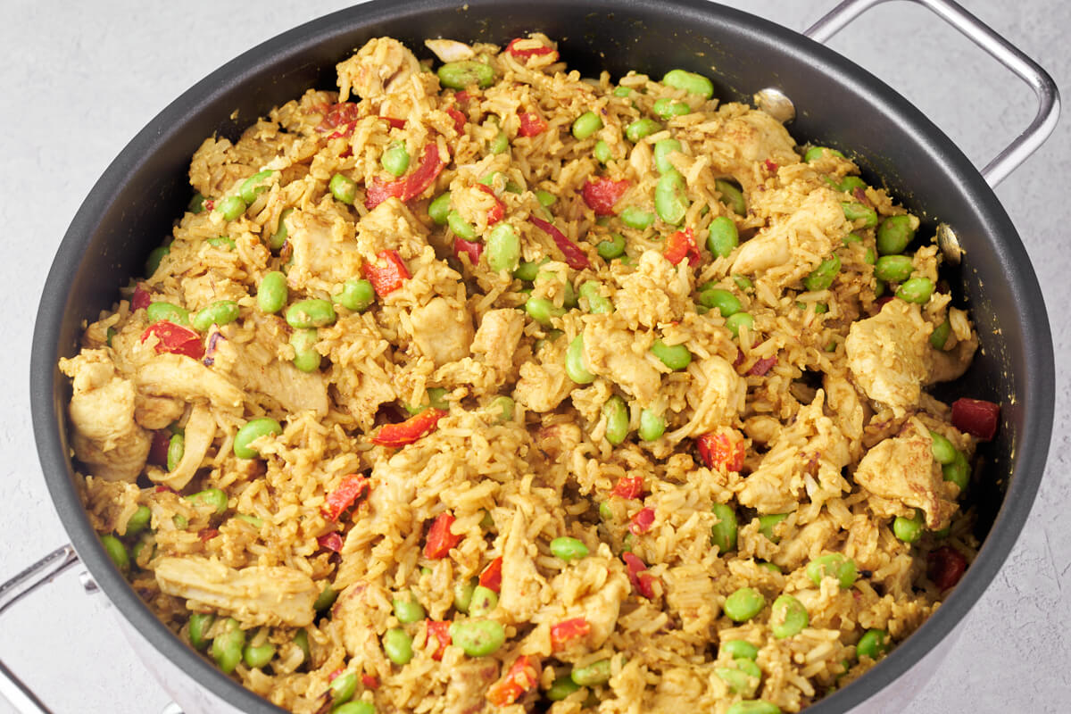 chicken fried rice with edamame beans and bell pepper in pan