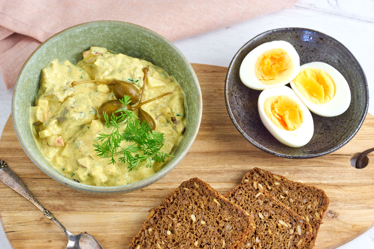 pickled herring in curry sauce with eggs and rye bread