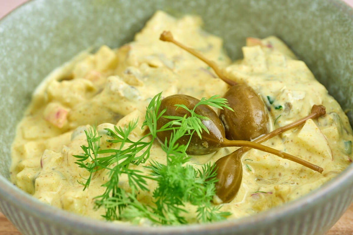 danish curry herring with caper berries on top