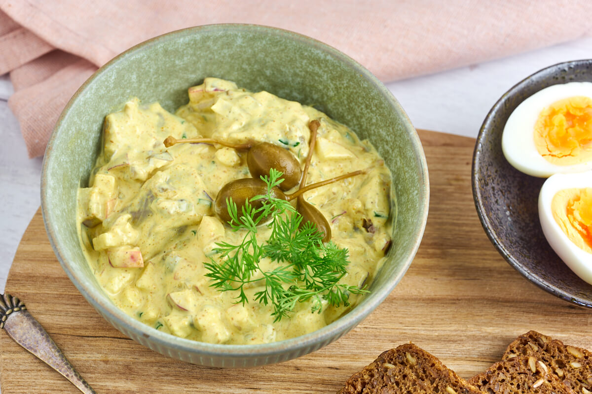 Danish curry herring or curried pickled herring served with hard boiled eggs and rye bread