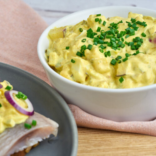 Danish curry salad for herring in bowl and on rye bread