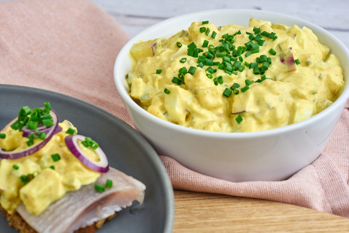 Danish curry salad for herring in bowl and on rye bread