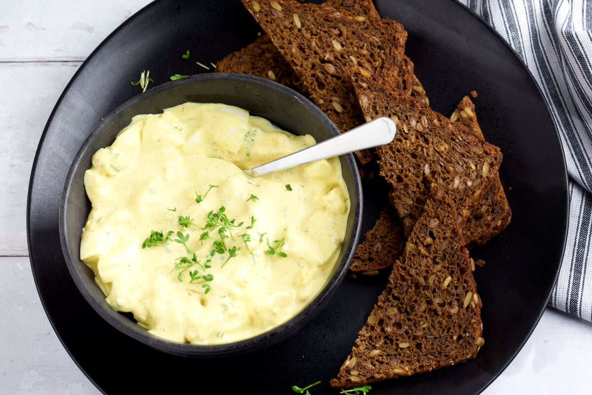 plate with egg salad and rye bread